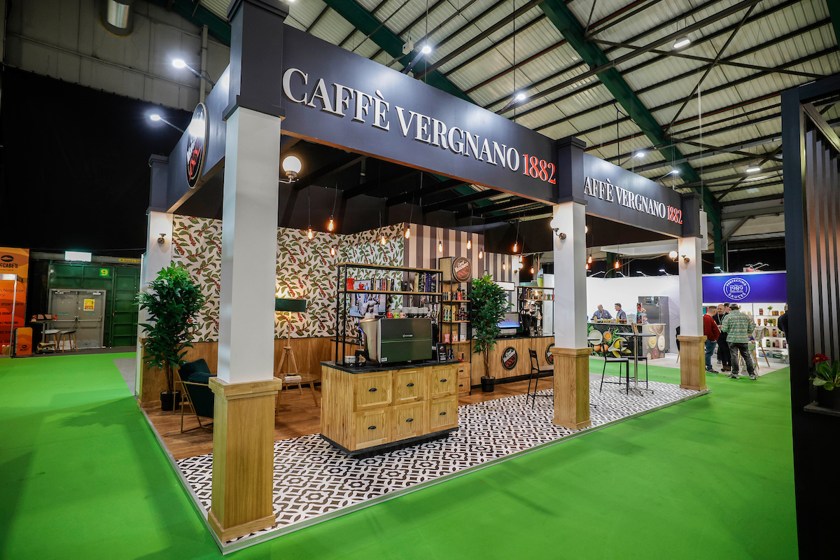 An impressive indoor exhibition stand, adorned with captivating exhibits, providing a delightful experience of the world of coffee. Expertly curated, it showcases the finest offerings of a renowned coffee company at the Catex event in Dublin